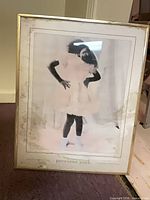 Front view of framed print shows image, mat staining, gold frame