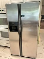Full view of Frigidaire stainless side-by-side refrigerator closed