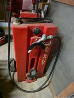 Side view of gas caddy showing volume markings, cap, hose, nozzle and GAS CADDY lettering