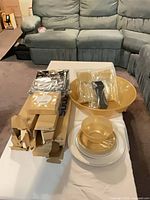 All items laid out: bowls, plates, cutlery, tablecovers, napkins