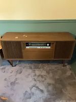 Full view of Grundig wood-veneer console stereo on legs