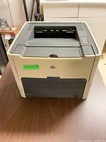 Front view of HP laser printer showing output tray and front panel