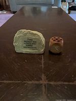 Plaque and pen holder side by side on table