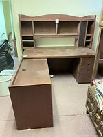 Overall view of L-shaped desk showing finish, drawers, return