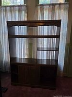 Full view of entertainment center showing shelves and cabinet