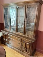 Front view of china cabinet showing leaded glass doors, drawers, lower doors