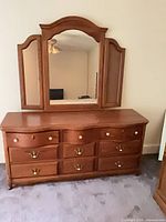 Front view of dresser with attached tri-fold mirror
