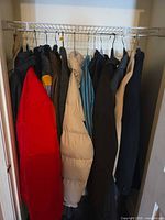 Full closet rail showing 15 coats and jackets