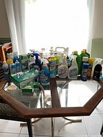 Full lot of assorted cleaners and soaps on table