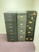 Front view of three vertical filing cabinets showing drawer layout and colors