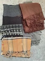 Group of five scarves showing colors and patterns