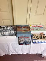 Group shot of all six boxed games on table