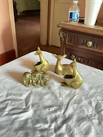 All four brass animal pieces displayed on tabletop