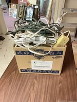 Box filled with mixed cords and power strips
