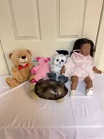 Group shot: teddy bear, pig plush, owl plush, turtle night-light, vinyl baby doll