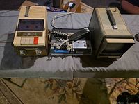 Three vintage electronics units side-by-side showing overall lot contents