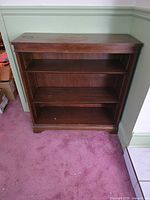 Full front view of bookshelf showing three shelves