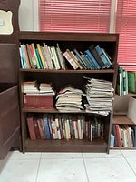 Front view showing three shelves filled with books