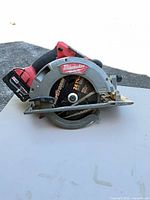 Left side view showing Milwaukee branding, blade, battery attached
