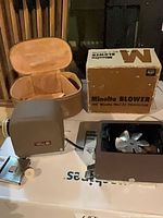 Projector, blower unit, blower box, carrying case, mounting bracket visible together