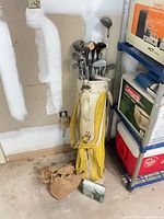 Full view of yellow bag, clubs, brown pouch and packaged tool kit
