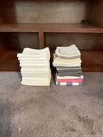 Two stacks of washcloths on carpet showing quantity and color mix