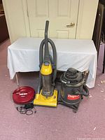 All three vacuums with accessories grouped together