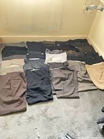 All pants laid out on floor showing variety