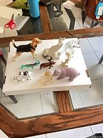 group shot of all ten animal figurines on white board