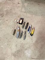 All knives, spare blades and holder laid out on floor