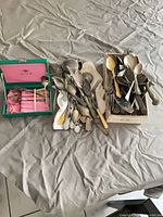 Overall view of three containers of assorted flatware