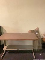 Full view of desk showing top, base, surrounding area