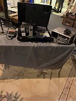 Entire lot on table showing case with phones, CB unit, accessories