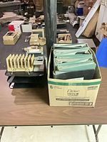 Overall lot: binders in box, letter trays stacked, file sorter