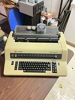 Olympia ES 101 Standard electric typewriter showing front keyboard and clear carriage cover
