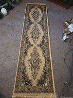 Full view of the 2' x 8' Oriental design runner rug showing overall pattern and fringe