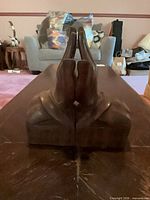 Pair of bookends side profile showing praying hands together