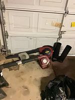 Both blowers with tubes on garage floor