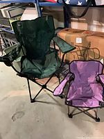 Adult green and child purple folding chairs side by side