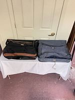Folded view of both garment bags side by side on table