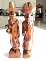 Front view of both carved wood figures
