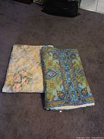Both quilts folded side by side showing different patterns