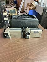 Both Sharp camcorders and carrying case on table