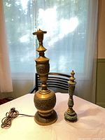 large and small brass/green marble lamps on table