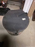Top view of drum case showing lid, strap and metal studs