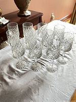Group of eleven Parka crystal stemmed wine glasses on table