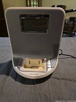 Front of Philips DC310/37X showing speaker grille, LCD, and 30-pin dock