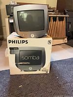 Front view of Philips Somba CRT TV sitting on its retail box