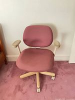 Front view of mauve fabric chair showing seat, backrest and beige arms