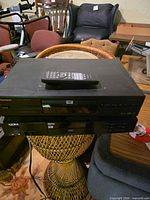 Stacked Pioneer DV-343 and Apex AD-600A DVD players with remote on top